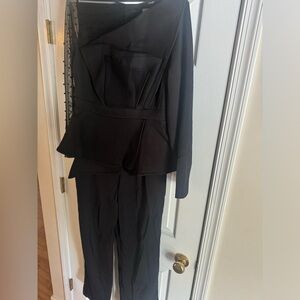 One piece black jumpsuit. Mesh collar with beads. Asymmetrical front
